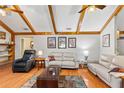 Cozy living room featuring vaulted ceilings, hardwood floors, and comfortable seating arrangements for relaxation at 2932 Chelsea Woods Dr, Valrico, FL 33596