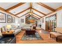 Bright living room with beamed vaulted ceiling, hardwood floors, and stylish furnishings, creating a welcoming atmosphere at 2932 Chelsea Woods Dr, Valrico, FL 33596