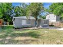 Delightful single-level house featuring a manicured lawn and a cheerful blue front door at 3003 E 27Th Ave, Tampa, FL 33605