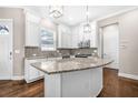 Bright kitchen with white cabinets, granite countertops, stainless steel appliances and large kitchen island at 307 S Gomez Ave # 1, Tampa, FL 33609
