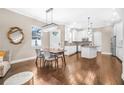 Open-concept kitchen and dining area with modern appliances and hardwood floors at 307 S Gomez Ave # 1, Tampa, FL 33609