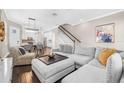 Open-concept living room and kitchen with a modern design, hardwood floors, and neutral color palette at 307 S Gomez Ave # 1, Tampa, FL 33609