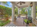 Charming covered porch with outdoor seating, a ceiling fan, and lush greenery at 356 22Nd Ne Ave, St Petersburg, FL 33704