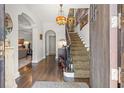 Grand foyer with hardwood floors, a curved staircase, and elegant light fixture at 356 22Nd Ne Ave, St Petersburg, FL 33704
