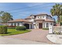 Beautiful home showcasing a Mediterranean design, tile roof, manicured lawn, and a circular driveway at 3931 Pompano Se Dr, St Petersburg, FL 33705