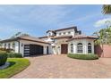 Stunning Mediterranean-style home with a tile roof, arched windows, and a paved driveway at 3931 Pompano Se Dr, St Petersburg, FL 33705