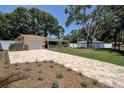 Lovely ranch home with a brick driveway, complemented by a well-manicured lawn and mature trees at 5072 98Th Way, St Petersburg, FL 33708