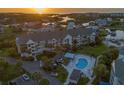 Exterior view of condos with community pool and Intracoastal view, surrounded by manicured landscaping and palm trees at 5537 Sea Forest Dr # 304, New Port Richey, FL 34652