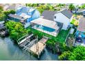 Aerial view of a waterfront property with a screened-in pool, private dock, and lush landscaping at 6509 Dolphin Cove Dr, Apollo Beach, FL 33572