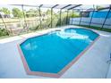 Inviting screened-in pool with brick trim and ample deck space, offering a private outdoor retreat at 6509 Dolphin Cove Dr, Apollo Beach, FL 33572