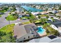 A picturesque aerial view features a charming house, lush greenery, and a tranquil bay setting at 680 Capri Blvd, Treasure Island, FL 33706