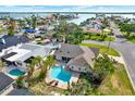 A captivating aerial view of a waterfront community showcases beautiful homes, canals, and stunning bay views at 680 Capri Blvd, Treasure Island, FL 33706