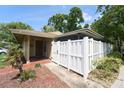 Inviting home featuring a private white-fenced courtyard and lush landscaping around the house at 7205 San Luis Ct, Tampa, FL 33634