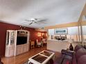 Open living room with a cozy dining area, television, and stylish decor, creating a warm and inviting space at 7910 Sun Island S Dr # 203, South Pasadena, FL 33707