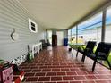Cozy screened patio featuring brick flooring, comfortable seating, and ample space for outdoor relaxation at 808 53Rd E Ave # 142K, Bradenton, FL 34203