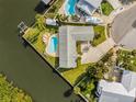 Aerial view of a waterfront home with two swimming pools and boat dock at 8727 Bay Crest Ln, Tampa, FL 33615