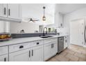 Beautiful, remodeled kitchen with white cabinets, stainless steel appliances, and tiled floors at 8727 Bay Crest Ln, Tampa, FL 33615