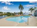 Backyard view of a pool, wooden dock, and waterway behind the house at 8727 Bay Crest Ln, Tampa, FL 33615