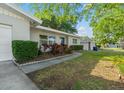 Well-kept single-story home with a blue front door, beautiful landscaping, and a lush green lawn at 1105 Oakview Ave, Clearwater, FL 33756