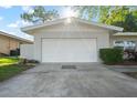 Attached white garage showcasing a clean, modern facade with manicured landscaping at 1105 Oakview Ave, Clearwater, FL 33756