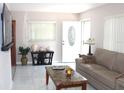 Cozy living room showcasing marble tile flooring, modern decor, and natural light at 12400 Park Blvd # 111, Seminole, FL 33772