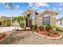 Attractive home with lush landscaping and a welcoming facade with decorative flags at 12531 Midpointe Dr, Riverview, FL 33578