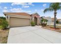 Well-maintained single-story home featuring a spacious driveway and manicured landscaping at 12531 Midpointe Dr, Riverview, FL 33578