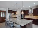 Spacious kitchen featuring a large island, stainless appliances, and pendant lighting at 13878 Allamanda Cir, Port Charlotte, FL 33981