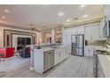 Spacious kitchen equipped with stainless steel appliances, white cabinetry, and a center island at 16106 Cedar Key Dr, Wimauma, FL 33598