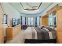 Serene main bedroom with tray ceilings, large windows, and ample closet space at 16106 Cedar Key Dr, Wimauma, FL 33598