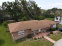 Aerial view of the single story home showing landscaping and a brown shingle roof at 1710 26Th S Ave, St Petersburg, FL 33712