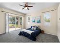 Serene bedroom with a sliding glass door to the patio, a ceiling fan, and neutral decor at 2019 Rutherford Dr, Dover, FL 33527