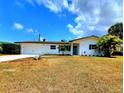 Inviting single-story home with a well-maintained lawn, attached garage, and classic design elements at 2172 University S Dr, Clearwater, FL 33764
