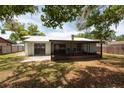 Enjoy the outdoors on this covered patio overlooking a spacious backyard with mature trees at 2336 Windsor Oaks Ave, Lutz, FL 33549