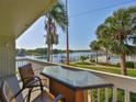Enjoy waterfront views from this balcony with seating, overlooking the pool and manicured grounds at 2424 W Tampa Bay Blvd # I202, Tampa, FL 33607