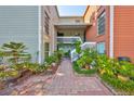 Exterior of condo complex with landscaping, brick walkway, and well-maintained facade at 2424 W Tampa Bay Blvd # I202, Tampa, FL 33607