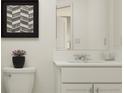 Clean bathroom featuring a single vanity with artwork above the toilet at 2681 Buttercup Lucine Ln, Ruskin, FL 33570