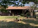 Backyard featuring a screened in porch, lush greenery, and ample room for gardening and outdoor activities at 31258 Park Ridge Dr, Brooksville, FL 34602
