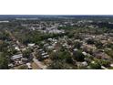 An aerial view showcases the neighborhood's layout and lush greenery at 38327 Palm Grove Dr, Zephyrhills, FL 33542