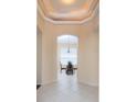 An elegant foyer leads into a dining area with a chandelier and large windows, creating a bright and welcoming atmosphere at 416 Durham Shore Ct, Apollo Beach, FL 33572