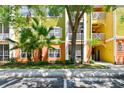Exterior of a colorful condo building with lush landscaping and balconies and parking out front at 4207 S Dale Mabry Hwy # 12206, Tampa, FL 33611