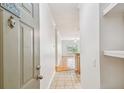 Bright hallway featuring tiled flooring and view into the living room with hardwood floors at 4207 S Dale Mabry Hwy # 12206, Tampa, FL 33611