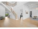 Grand foyer with a modern staircase, beautiful wood floors, and high ceilings at 4300 Bayshore Ne Blvd, St Petersburg, FL 33703
