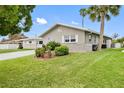 Well-maintained single-story home featuring a landscaped yard and a charming dolphin accent at 5047 Bonito Dr, New Port Richey, FL 34652