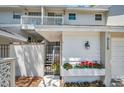 Charming entrance featuring a gated entry and bright red flowers adding a pop of color to the home's exterior at 5115 S Jules Verne Ct, Tampa, FL 33611