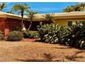 This home's front yard features mature plants and trees and an eye-catching brick accent on the front of the house at 530 59Th Ave, St Pete Beach, FL 33706