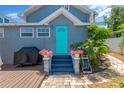 Charming home backyard featuring blue accents, a grill, patio, and lush landscaping at 655 33Rd Ave N, St Petersburg, FL 33704