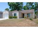 Charming single-story home with well-maintained landscaping, attached garage and neutral paint at 6805 S Gabrielle St, Tampa, FL 33611