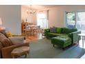 Stylishly furnished living room with a cozy seating area, ample natural light, and an adjacent dining area at 6805 S Gabrielle St, Tampa, FL 33611