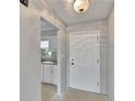 Bright entryway featuring tiled floors, neutral paint, and a view into the kitchen at 814 Seabreeze Dr, Ruskin, FL 33570